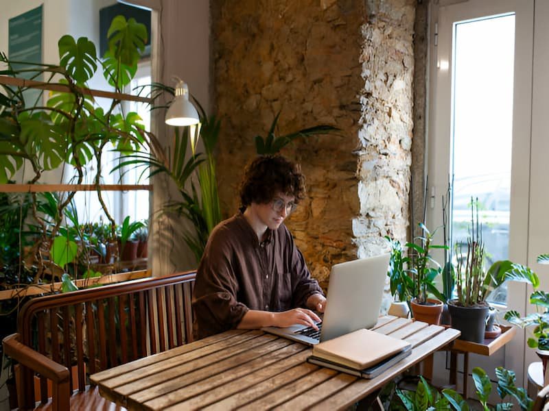 Nomad at Algarve beach cafe, enjoying the Best Cities in Portugal for Digital Nomads