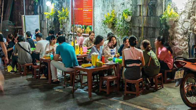 Hidden food alley in Hanoi with locals dining on plastic stools