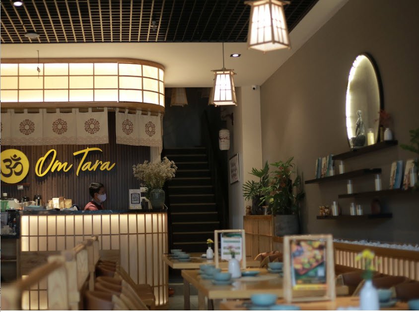 Elegant interior of upscale vegetarian restaurant in Hanoi with beautifully plated dishes