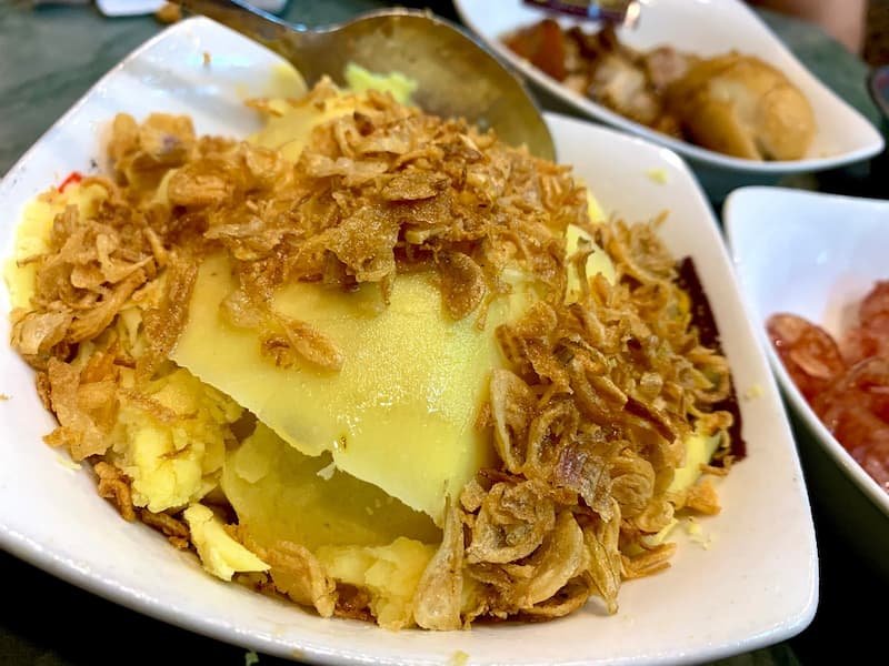 Authentic xoi xeo sticky rice with toppings at Xoi Yen in Hanoi