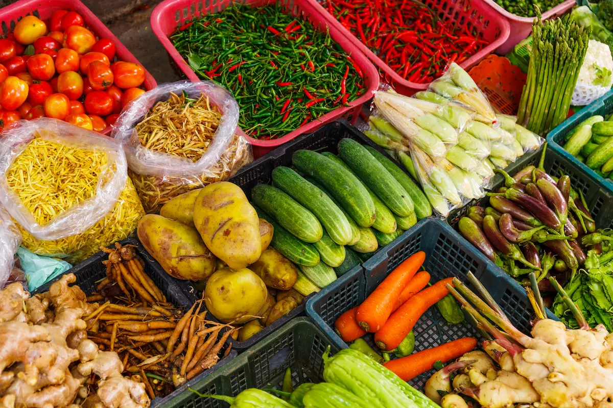 Colourful fresh vegetables, fruits and spices at a Cambodian market with prices significantly lower than neighbouring Thailand, attracting budget travellers