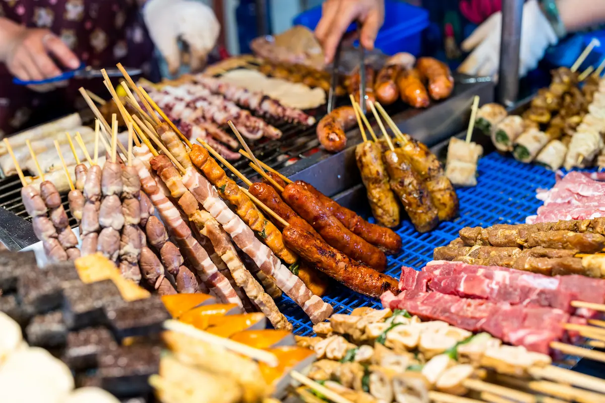 Skewered meats and seafood at a Cambodian street food stall selling affordable $1-2 grilled items, highlighting Cambodia's budget-friendly culinary appeal