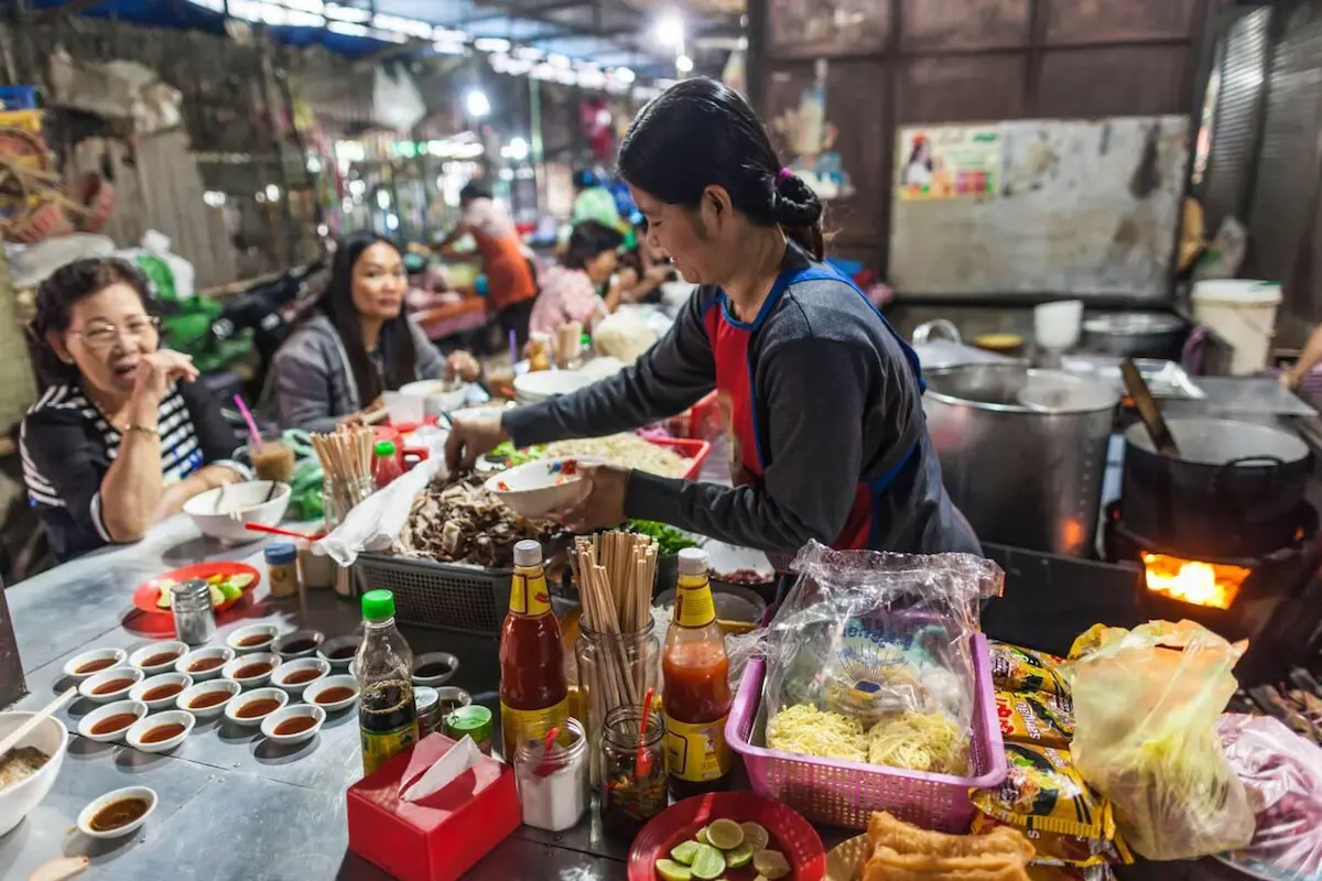 Vibrant local market in Battambang where budget travelers can purchase fresh produce and sample authentic Cambodian food for $1-3, far less than in tourist-oriented markets
