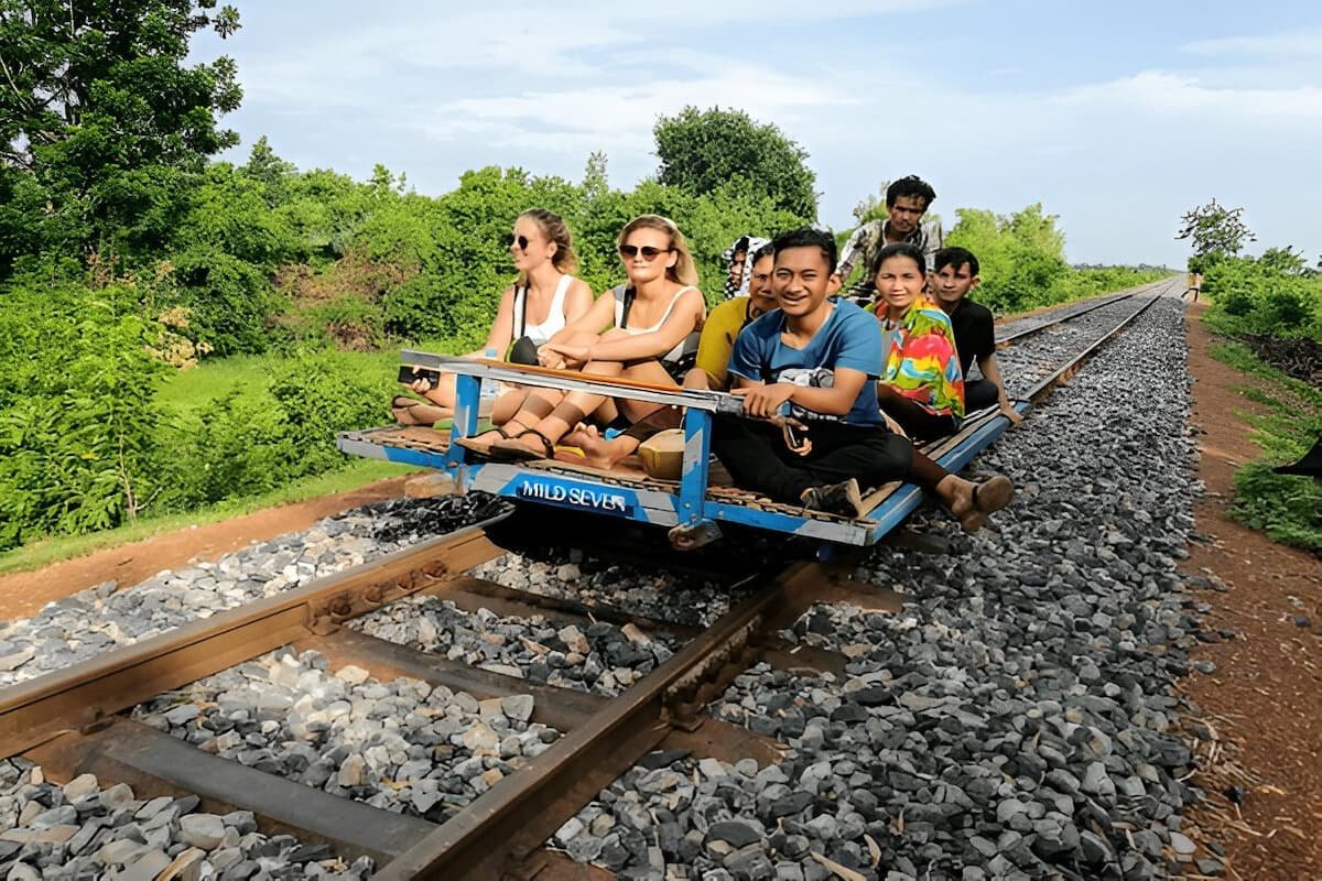 Tourists enjoying the bamboo train experience through Battambang's rural landscapes