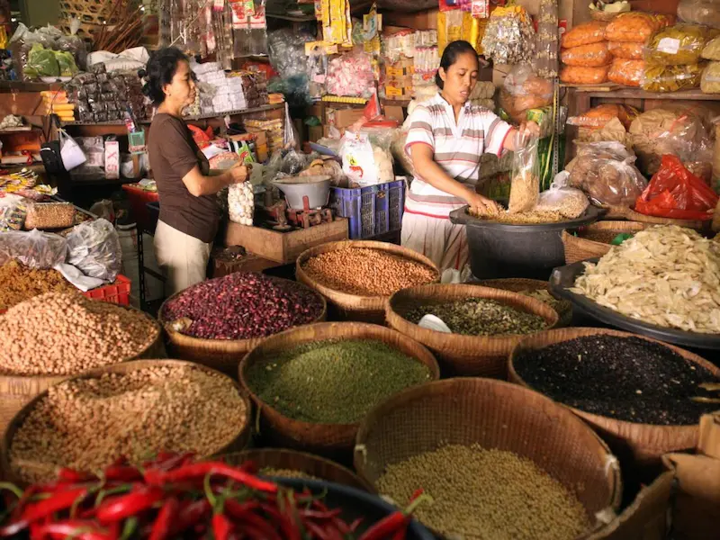 Bustling early morning scene at Pasar Badung traditional market in Jakarta