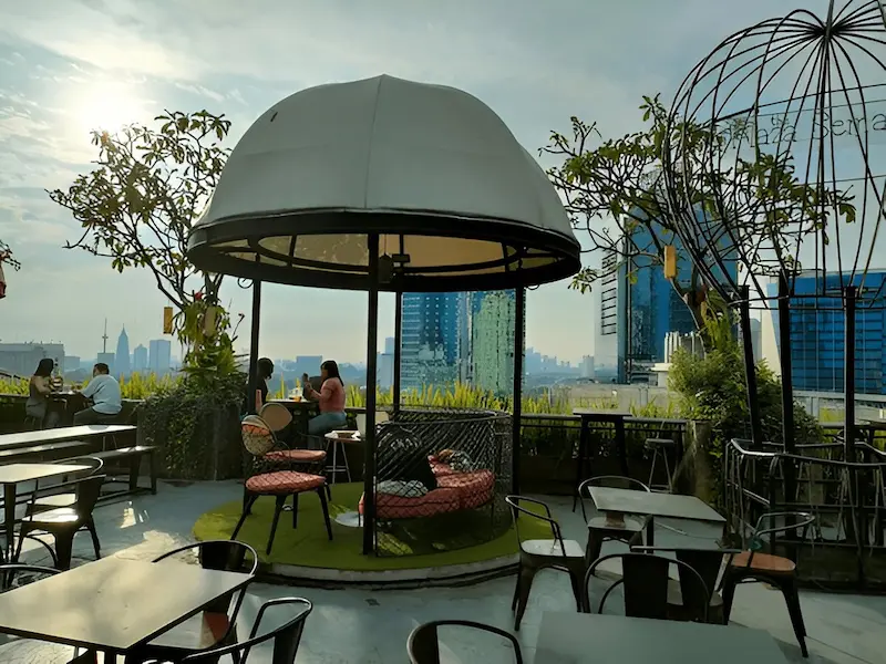 Sunset view from a luxurious rooftop bar overlooking Jakarta's skyline