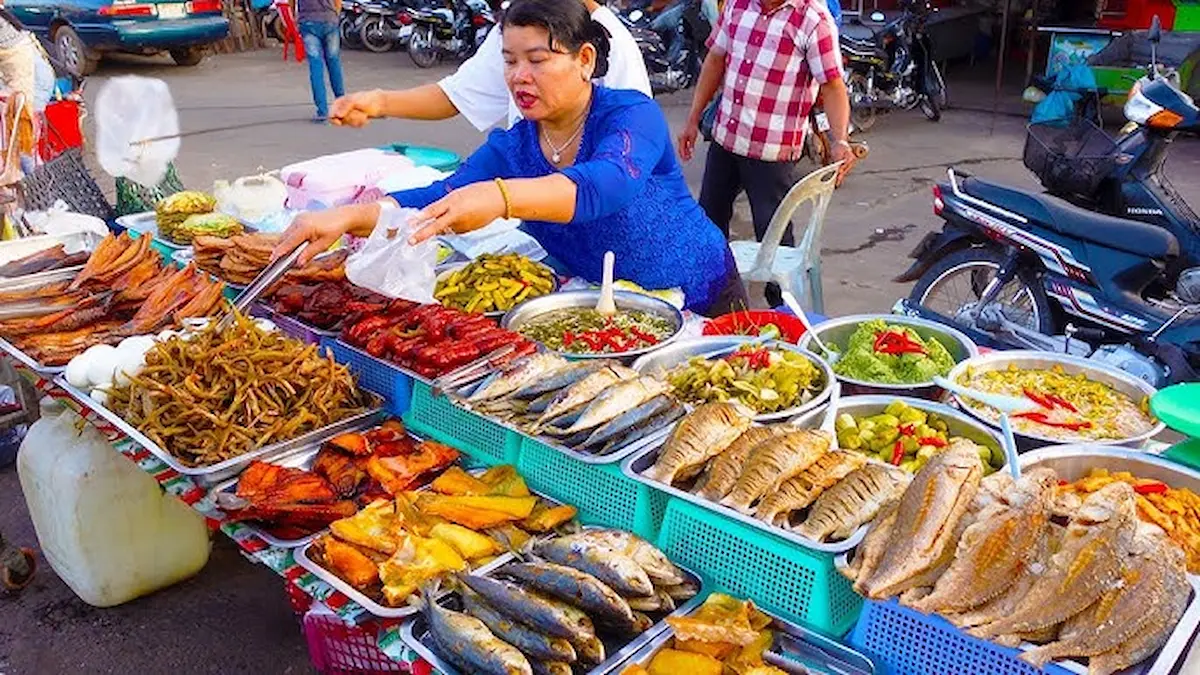 woman serving food at a Cambodian street food market